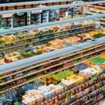 Explore the colorful, fully-stocked shelves of a bustling supermarket from above.